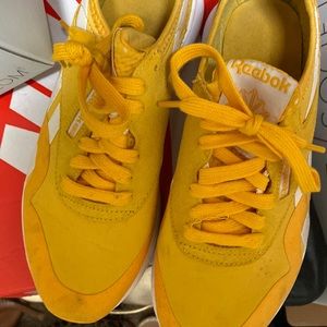 Yellow Reebok sneakers.